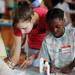 Michigan junior Corrine Carter colors with her pen pal Carpenter Elementary student Ayanah Freeman, 8, during the 14th Annual Kids' Fair at University of Michigan on Friday. Melanie Maxwell I AnnArbor.com